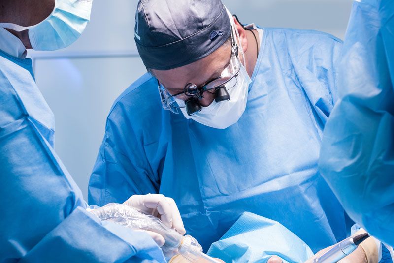 a dentist performing a tooth extraction on a patient.