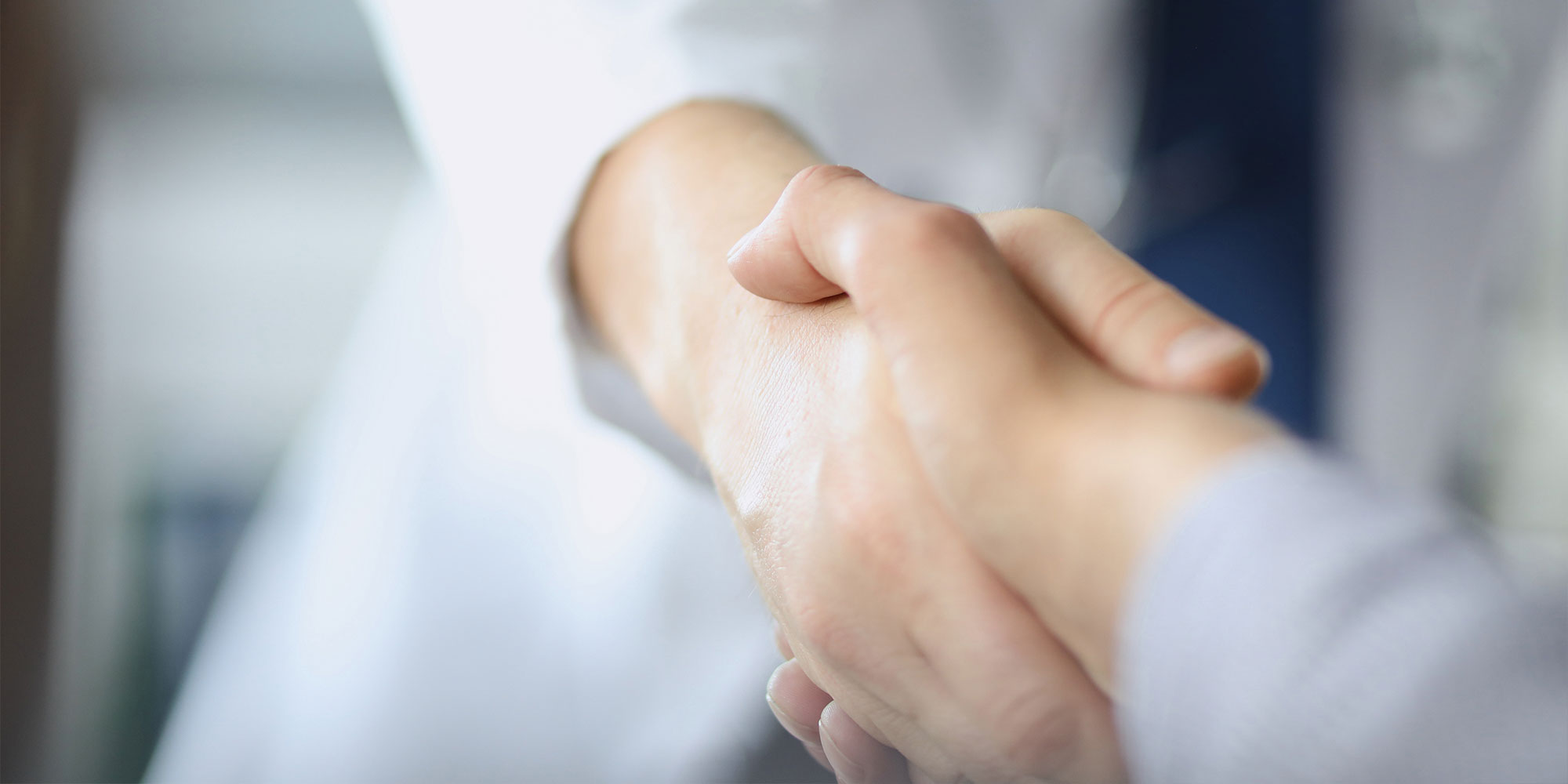 patient and doctor shaking hands after dental procedure